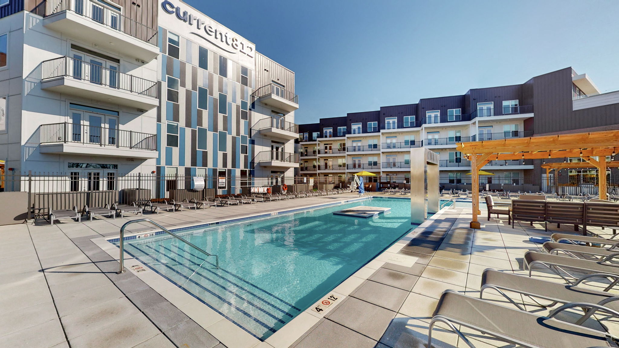 a swimming pool in front of a building with a pool